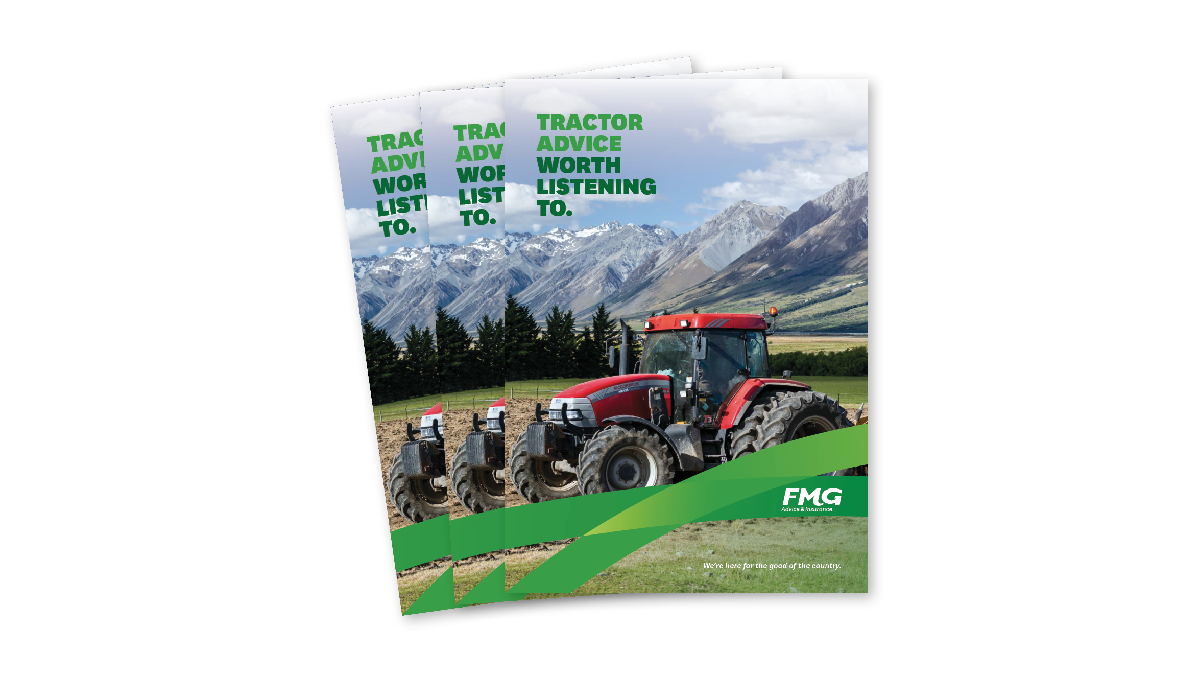Tractor working in front of mountain range 